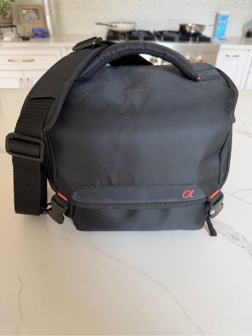 Sony Black Compact Messenger Camera Bag with Red Accent